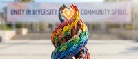 Hands painted in rainbow colors forming heart shape, symbolizing unity, diversity, and community spirit for inclusive campaigns and social causes.