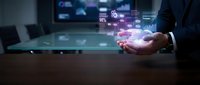 Businessman hand holding holographic data visualization with digital analytics charts and statistics floating above modern workspace technology.