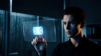 Man holding digital envelope icon on transparent screen, representing email communication and digital messaging technology.