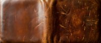 Rich brown leather texture with natural grain patterns and vintage weathered surface showing authentic wear and scratches for luxury design projects.
