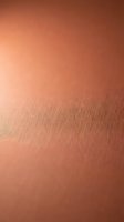 Warm copper metallic surface with brushed texture and subtle gradient lighting, suitable for backgrounds and design projects.