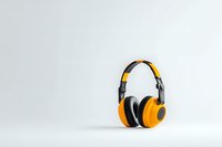 Modern yellow and black wireless headphones on white background, professional audio equipment for music and sound recording isolated with copy space.