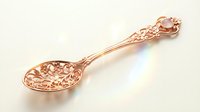 Ornate copper spoon with intricate floral patterns and decorative handle on white background, perfect for kitchen decor, cooking utensils, and culinary designs.