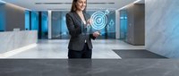Professional businesswoman using holographic digital interface technology in modern corporate office environment for futuristic business solutions.
