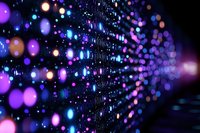Glowing purple and blue bokeh lights creating magical sparkle effect against dark background, defocused abstract pattern with blurred illumination dots.
