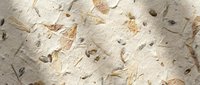 Handmade paper texture with natural fibers and organic materials embedded creating rustic artisan surface for craft projects and design backgrounds.