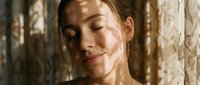 Woman with wet hair and closed eyes standing against weathered wooden wall, water droplets on face, serene expression, suitable for wellness, skincare, and spa marketing materials.