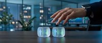 Businessman hand hovering over glowing holographic cubes displaying upward arrows in modern office at night representing growth and digital innovation.