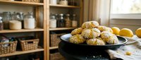 Freshly baked golden dinner rolls arranged on dark plate in cozy farmhouse kitchen with wooden shelves and pantry jars for family meals and cooking.