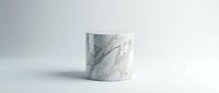 White marble cylinder podium with gray veining on clean background for product display and presentation purposes.