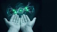 Cupped hands holding glowing green energy orb with flowing light streams on dark background for fantasy and supernatural concepts.