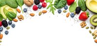 Fresh organic superfood ingredients frame with berries, nuts, seeds and greens on white background for healthy eating and nutrition concepts.