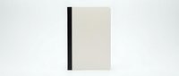 Minimalist notebook with black spine and cream cover on white background, isolated for design projects and branding mockups.