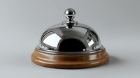 Service bell with polished chrome dome cover on wooden base against neutral background, ready for hospitality and customer service concepts.