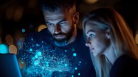 Young diverse couple looking at glowing blue holographic projection with particles and digital elements in dark room with bokeh lights background.