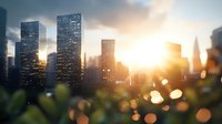 Modern cityscape with glowing sunset behind skyscrapers, urban skyline silhouettes against warm evening sky, bokeh lights in foreground creating dreamy atmosphere.