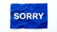 Crumpled blue paper with white bold text SORRY on white background, conveying apology, regret, and forgiveness concepts.