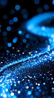 Shimmering blue glitter particles scattered on dark background create magical bokeh effect with blurred lights and sparkles for festive designs and celebrations.
