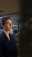 Woman professional with eyes closed wearing dark blazer with digital neural network overlay visualization representing artificial intelligence, machine learning, and cognitive technology for business applications.