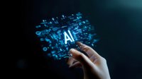 Glowing AI text with digital elements floating above human hand reaching towards futuristic holographic display against dark background, representing artificial intelligence technology.