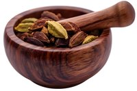Aromatic cardamom pods in wooden mortar bowl, mix of green and brown pods on white background, isolated spice ingredient for cooking and flavoring.