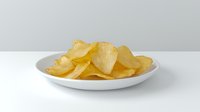 Crispy potato chips arranged on round white ceramic plate against neutral gray background, showcasing golden color and texture of fresh snack food.
