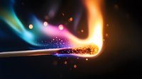 Burning match with colorful flame and sparks against dark background, macro photography capturing moment of ignition with vibrant blue and orange light effects.