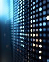 Abstract technology background with glowing LED dots pattern in blue tones, creating depth and perspective effect for digital media and tech presentations.