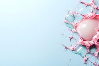 Pink liquid crown splash frozen in motion against light blue background, dynamic fluid art photography with negative space for text placement.