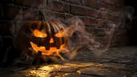 Carved jack-o-lantern pumpkin with glowing face and swirling smoke against brick wall, suitable for autumn, holiday, and seasonal marketing materials.