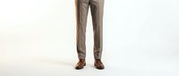 Professional businessman legs in gray suit trousers and brown leather dress shoes standing on white background for business and corporate design.