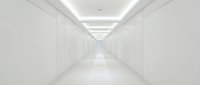 Modern white corridor with clean lines and LED ceiling lighting creating perspective depth for architectural and interior design projects.