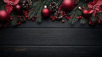 Festive Christmas border with red ornaments, poinsettias, pine cones, and evergreen branches on dark wooden background.