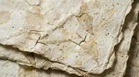 Old weathered handmade paper sheets with torn edges and natural fiber texture for vintage crafting and artistic projects.
