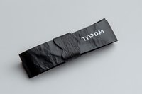 Black textured fabric headband with white text branding, isolated on neutral background. Suitable for sportswear mockups, athletic accessories, and promotional designs.
