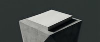 Modern concrete cube table with geometric cutout design on dark background for contemporary interior decor and minimalist furniture concepts.