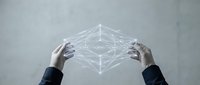 Business hands holding glowing network cube with connected nodes representing digital transformation and technology innovation concepts.