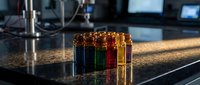 Laboratory test tubes with colorful chemical solutions on research bench in modern scientific facility for medical analysis and experimentation.