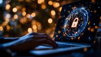 Digital security lock symbol on laptop screen with glowing cyber circle and hands typing on keyboard against blurred bokeh lights background.
