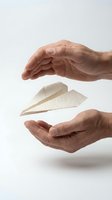 Male hands of Middle Eastern or South Asian descent protecting paper airplane in mid-air against white background, symbolizing care, fragility, and safe delivery for business concepts.