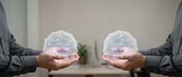 Two business professionals holding glowing digital network spheres with connected nodes, representing global connectivity and data exchange in modern workplace.