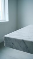 Minimalist marble countertop edge in modern kitchen with sage green walls and natural window light creating clean contemporary interior design.