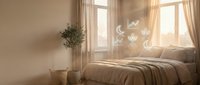 Serene bedroom with soft sunlight streaming through sheer curtains, cozy bed with neutral bedding, potted plant, and dreamy moon and cloud window decals.