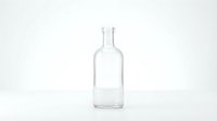 Empty clear glass bottle isolated on white background for product mockup and packaging design projects.