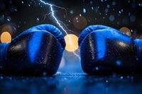 Blue boxing gloves facing each other on dark surface with dramatic lightning strike and bokeh lights in background, creating atmospheric sports composition.