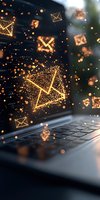 Glowing email envelope icons floating above laptop keyboard with magical sparkle effects and bokeh lights, representing digital communication and messaging.