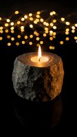Stone candle holder with burning flame against warm bokeh lights background creating cozy atmospheric mood for relaxation and meditation.