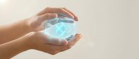 Hands holding glowing digital hologram cube with technology interface, representing innovation, data protection, and future digital solutions for business applications.