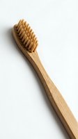 Natural bamboo toothbrush with soft bristles isolated on white background for eco-friendly dental care and sustainable oral hygiene products.