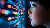 Young Asian boy looking at futuristic digital interface with glowing blue lights and bokeh effects, representing technology advancement and digital transformation.